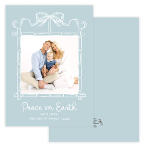Holiday card with a family photo and 'Peace on Earth' text on a light blue background