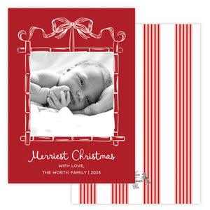 Christmas card with a baby photo and red bamboo border featuring a bow.