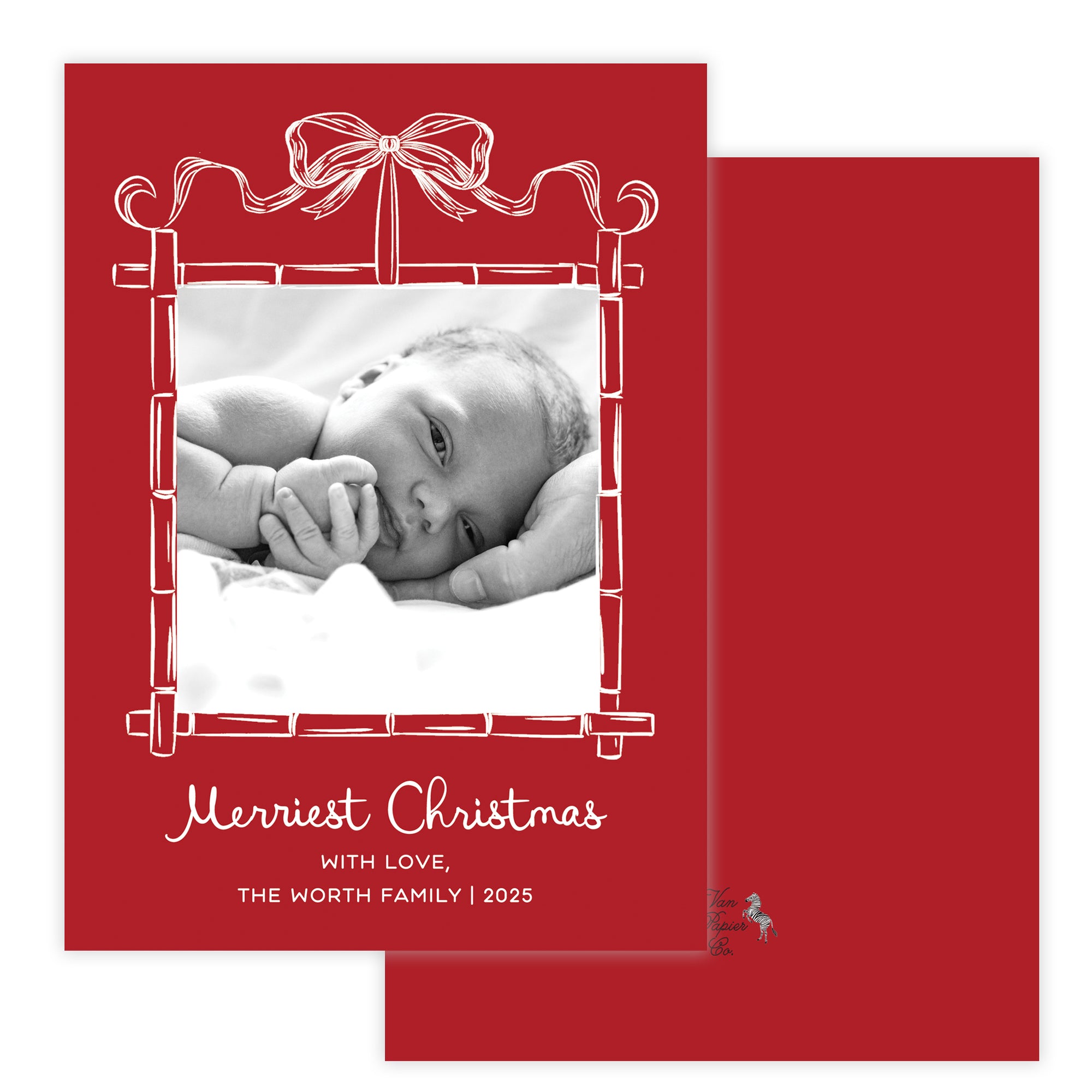Christmas card with a baby photo and red bamboo border featuring a bow.