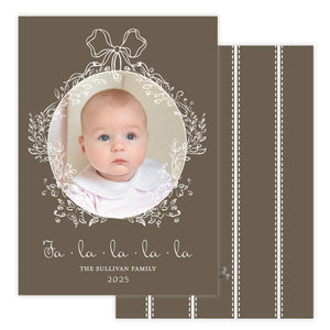 Baby photo card with decorative elements and text on a brown background