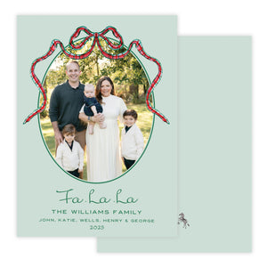 Christmas photo card with decorative bow on a light green background.