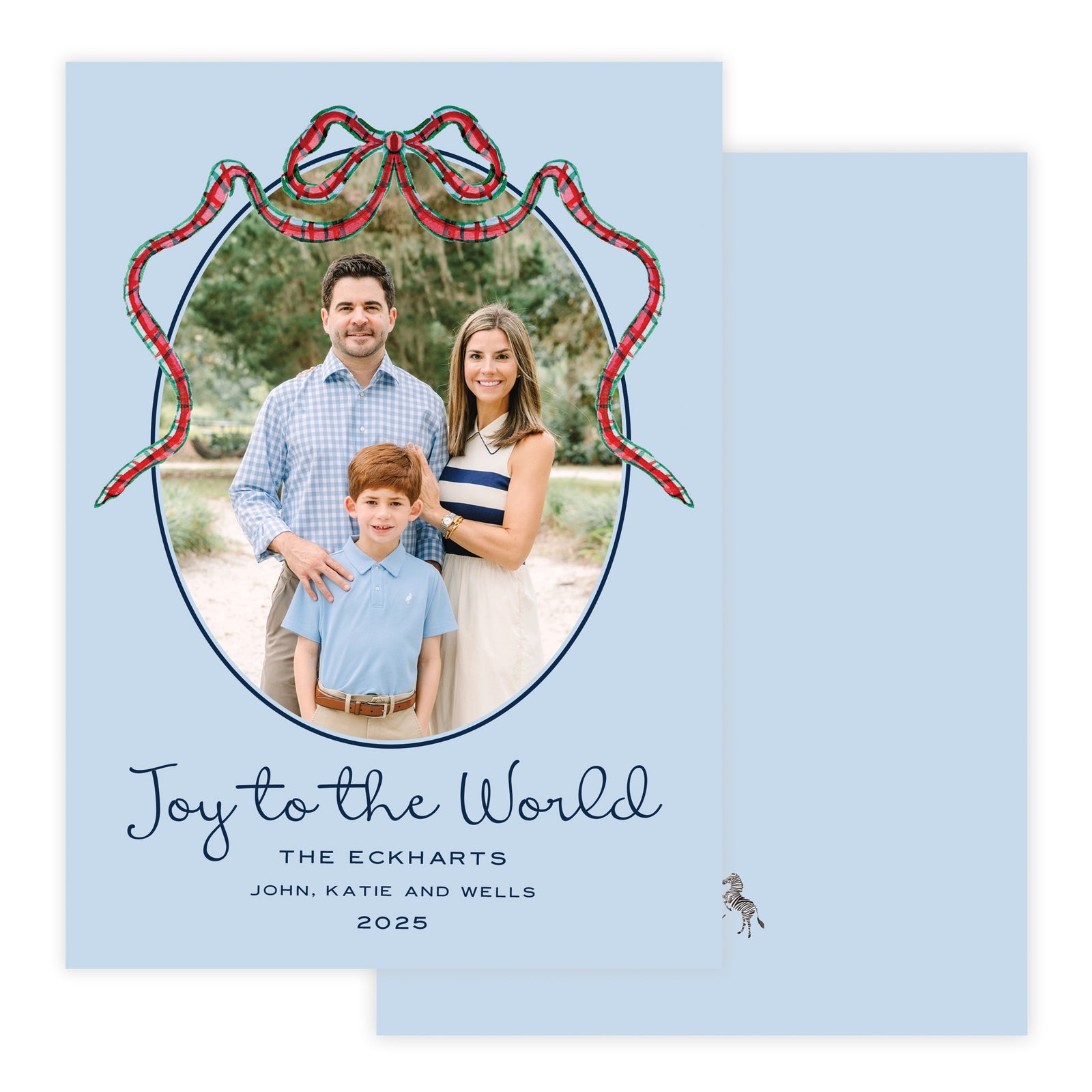 Christmas photo card with decorative bow on a light blue background.