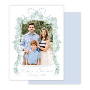 Christmas card with a family photo and decorative garland border.