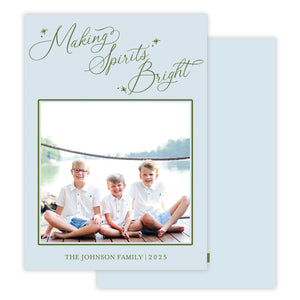 Holiday card with photo of three children and text 'Making Spirits Bright' on a light blue background.