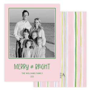 Holiday card with family photo and 'Merry and Bright' text on a pink background