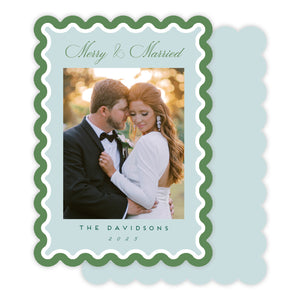 Greeting card with a couple embracing, text 'Merry & Married' on a light blue background.
