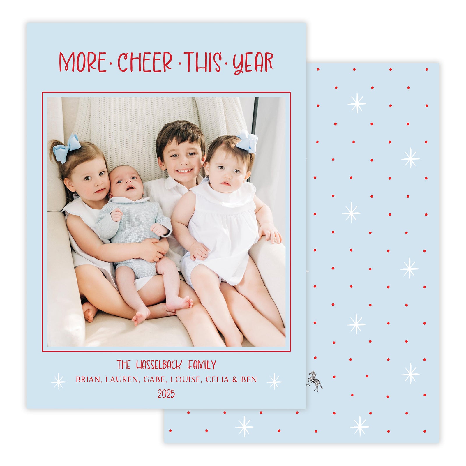 Holiday card with children and text 'More Cheer This Year' on a blue background with red dots and white stars.