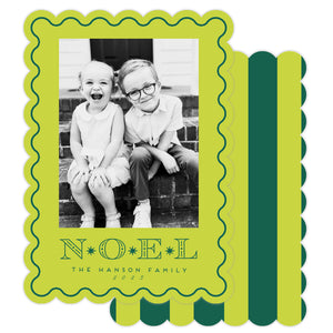 Holiday card with black and white photo of two children and 'NOEL' text on a green border.