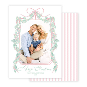 Christmas card with a family photo and decorative garland border.