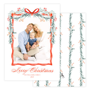Christmas card with a family photo and decorative garland border and red bow.