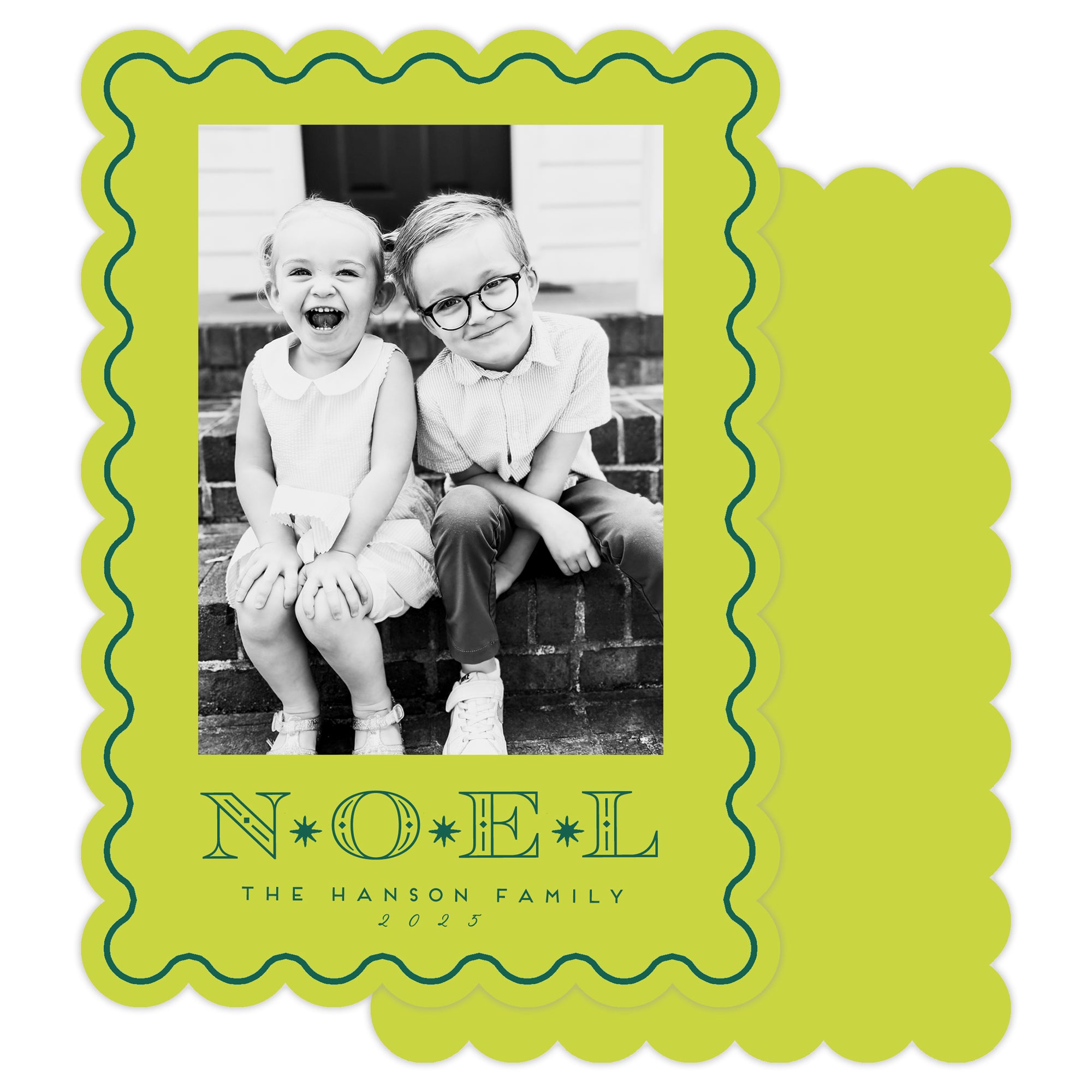 Holiday card with black and white photo of two children and 'NOEL' text on a green border.