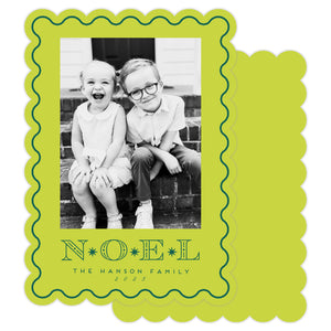 Holiday card with black and white photo of two children and 'NOEL' text on a green border.