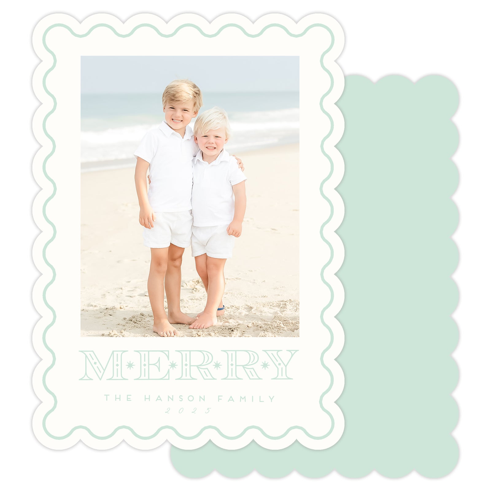 Two children on a beach with a 'Merry' card design overlay