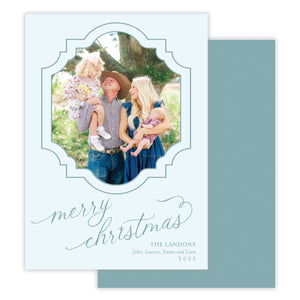 Christmas card with a family photo and 'merry christmas' calligraphy text on a light blue background