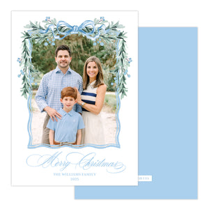 Christmas card with a family photo and decorative garland on a light blue background