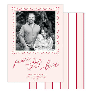 Holiday card with family photo and 'peace joy love' text on a pink background