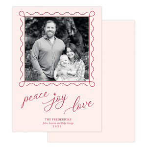 Holiday card with family photo and 'peace joy love' text on a pink background